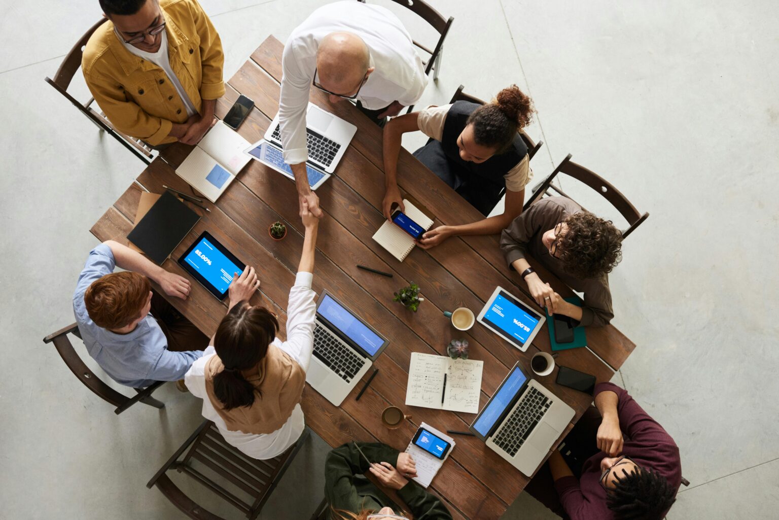 Group of multi cultural people sitting around a table.
